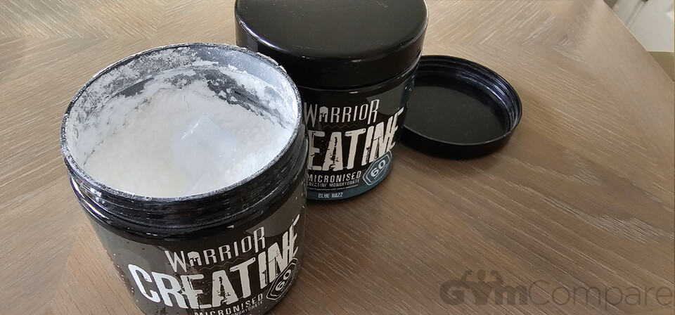 Two tubs of Warrior Creatine, one with the lid off and one closed.