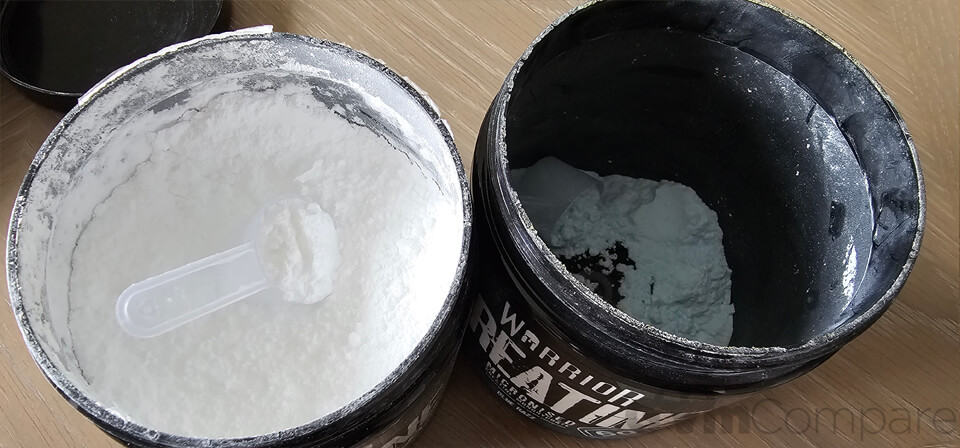 Two tubs of Creatine open, one full and one nearly empty.